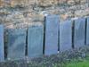 Headstones against a wall